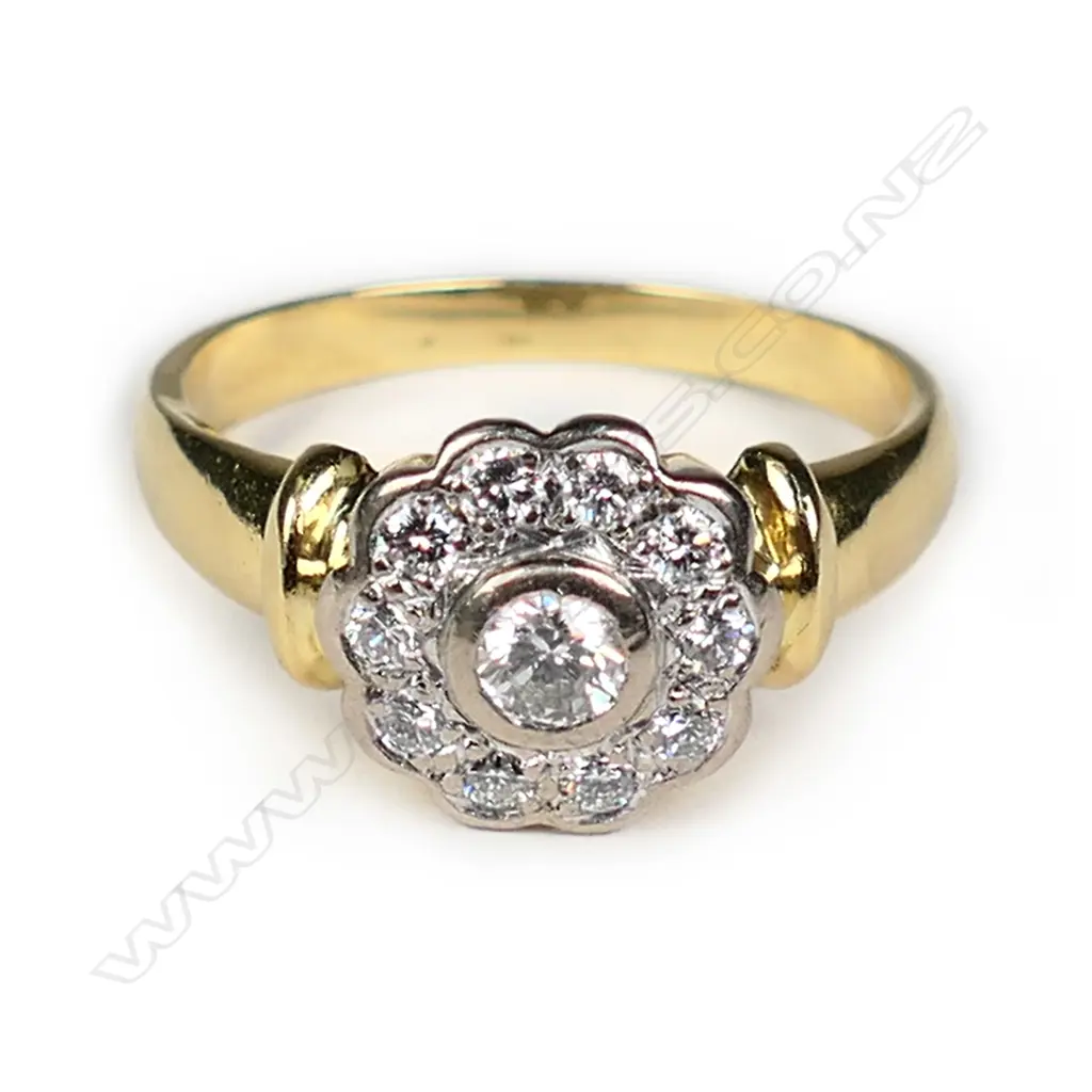 An 18ct gold and diamond cluster ring Image 1++