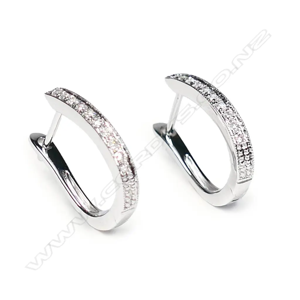 A pair of 9ct white gold and diamond earrings Image 1++