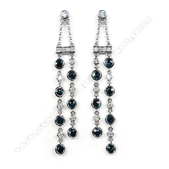 A pair of 14ct white gold diamond and sapphire drop chain earrings
