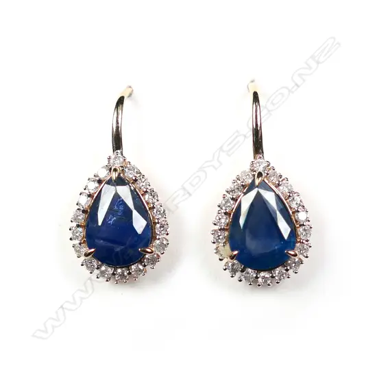 A pair of 14ct rose gold blue sapphire and diamond halo earrings
