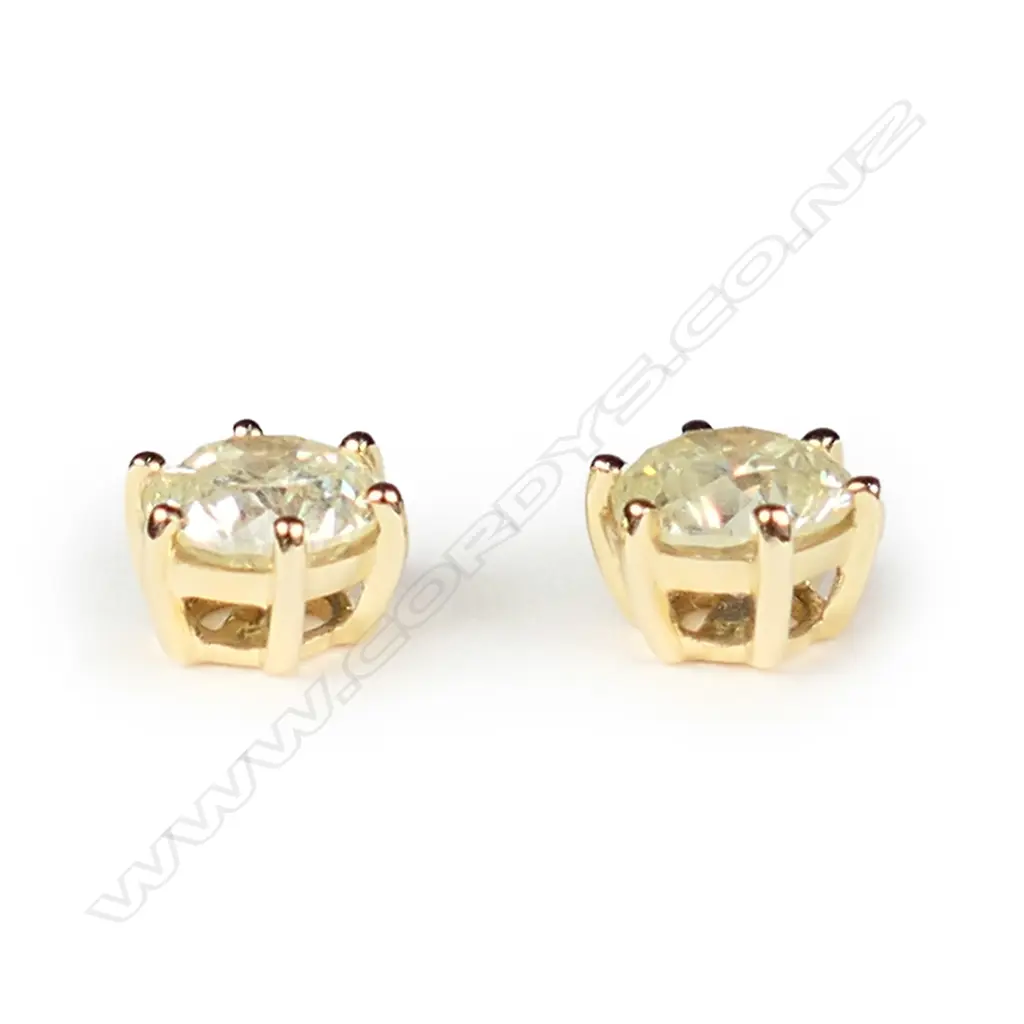 A pair of 14ct yellow gold and diamond stud earrings Image 1++