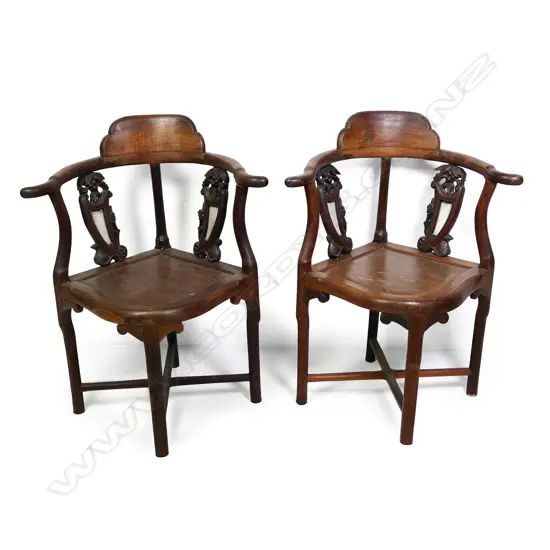 A pair of old Oriental rosewood corner chairs
