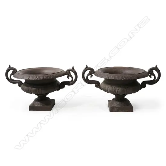 A pair of cast iron garden urns