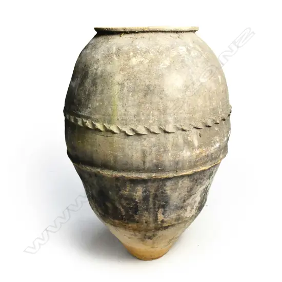 An old European terracotta tall olive oil storage jar