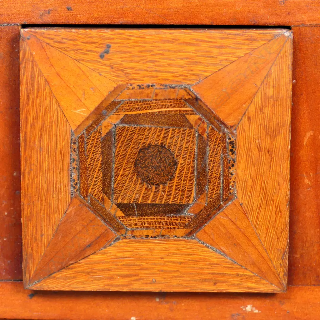 A New Zealand native timbers miniature scotch chest, kauri, puriri, rewarewa and other timbers, the central top drawer with concealed spring latch/release. Four handles damaged or replaced. 290 x 180 x 350mm. Image 1++