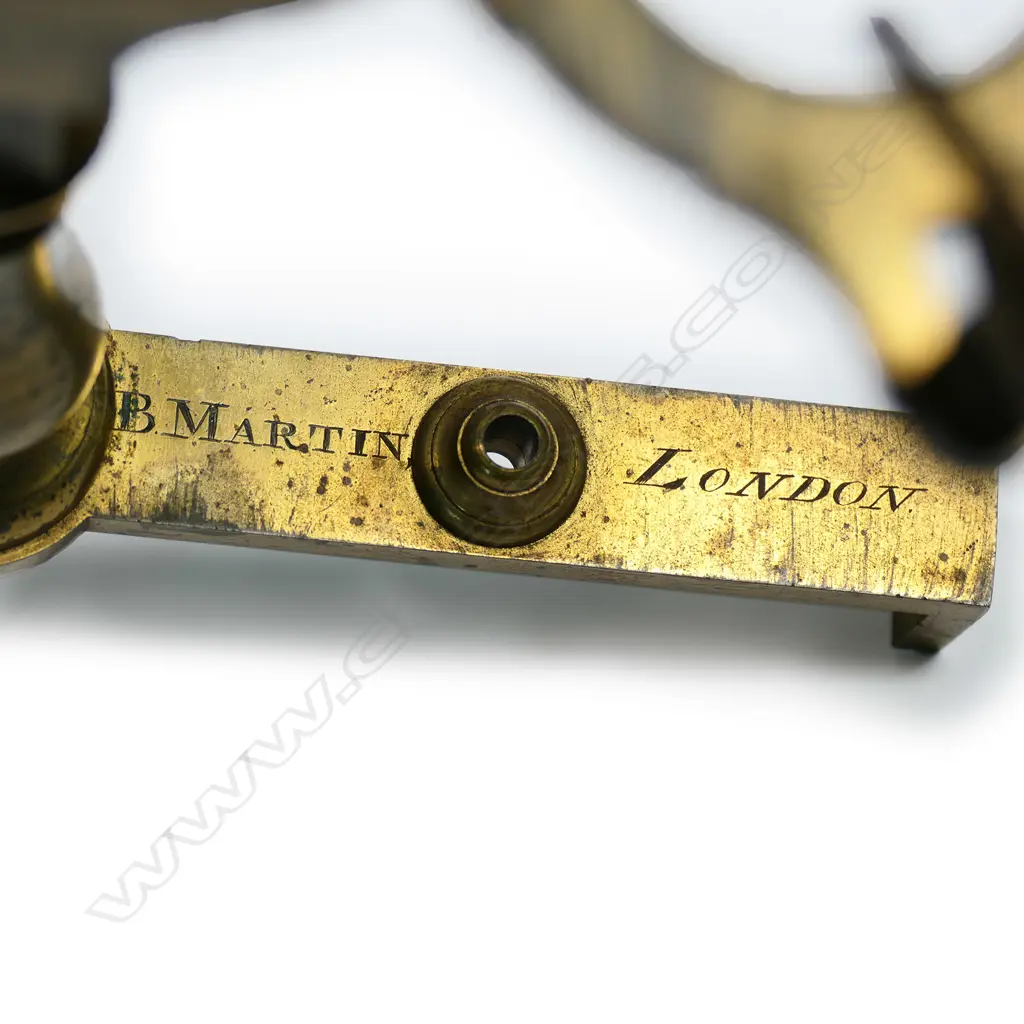 An early brass compound microscope by Benjamin Martin c.1775, the tube on a pivot hinge above a rack and pinion stage adjuster and baluster column from a folding tripod base, signed B. Martin, London. In original shagreen covered box with various additional lenses and parts. The case distressed. Image 1++