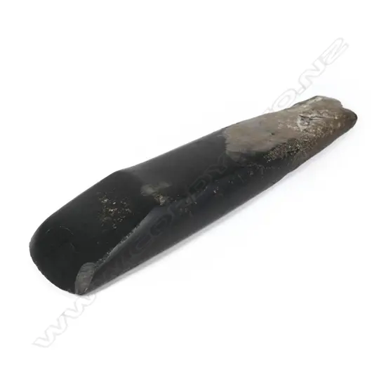 A pre–European Māori long toki, tapered form of rectangular cross-section, over-all in good polish, of metasomatised argillite; black with pale section at poll end. L.245mm. Registered Y20435.