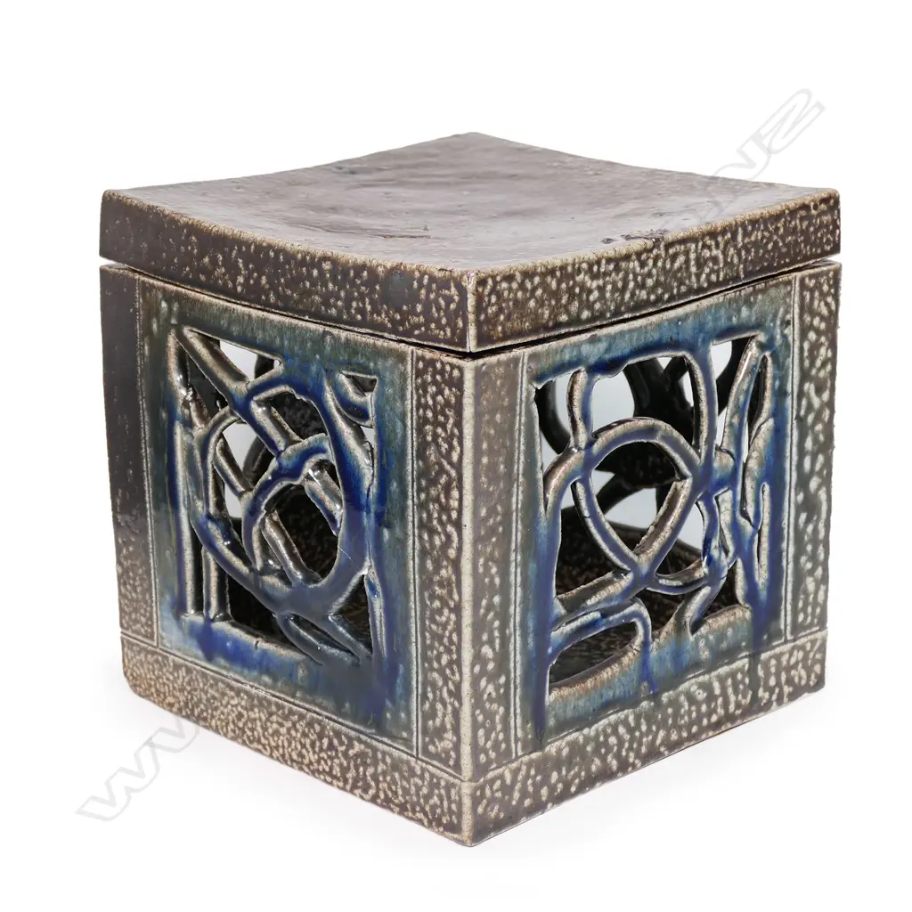 Warren Tippett large salt glazed square lidded box, rich dark brown with abstract pierced cut side panels with blue/green glaze. 210 x 210 x 220mm. Illustrated NZ Potter 1979, copy enclosed. Image 1++