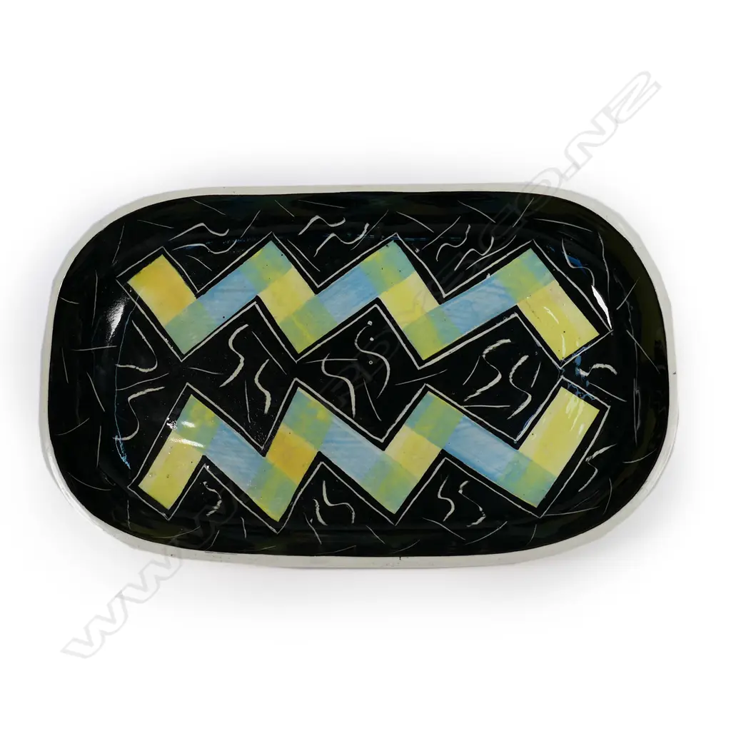 Warren Tippett rectangular dish, abstract blue and yellow zig-zag decoration on black ground with S-scroll and lineal decoration. Signed and dated '83. 317 x 195mm Image 1++