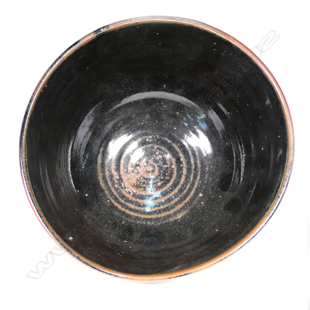 Warren Tippett wax resist tenmoku bowl, leafy sprig decoration. Impressed potter's mark, Coromandel. Dia.225mm. Image 1++