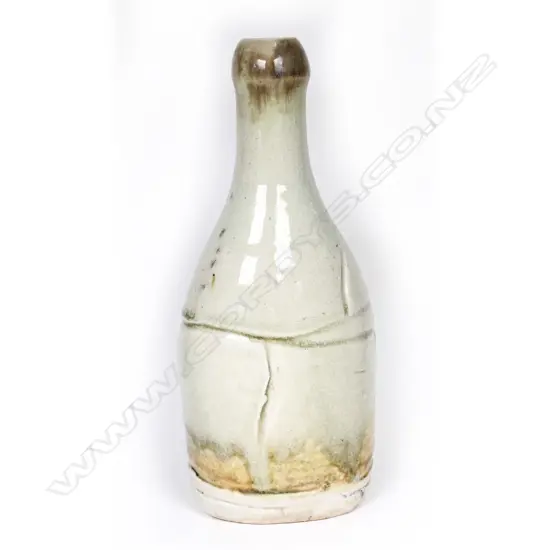 Denis O'Connor salt glazed bottle, broad incised panels to the oval section body, gloss pale green glaze, tan to the top and base. Impressed mark. H.230mm.