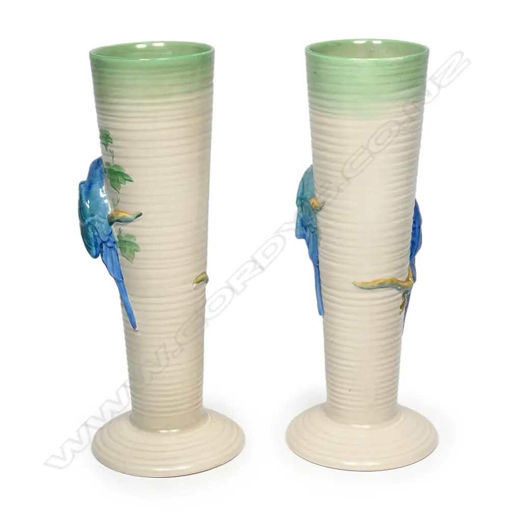 A pair of Clarice Cliff vases, shape 978, tapering conical, each modelled with two budgerigars in high relief. Printed backstamp and NZ retailer's decal. H.320mm. Image 1++