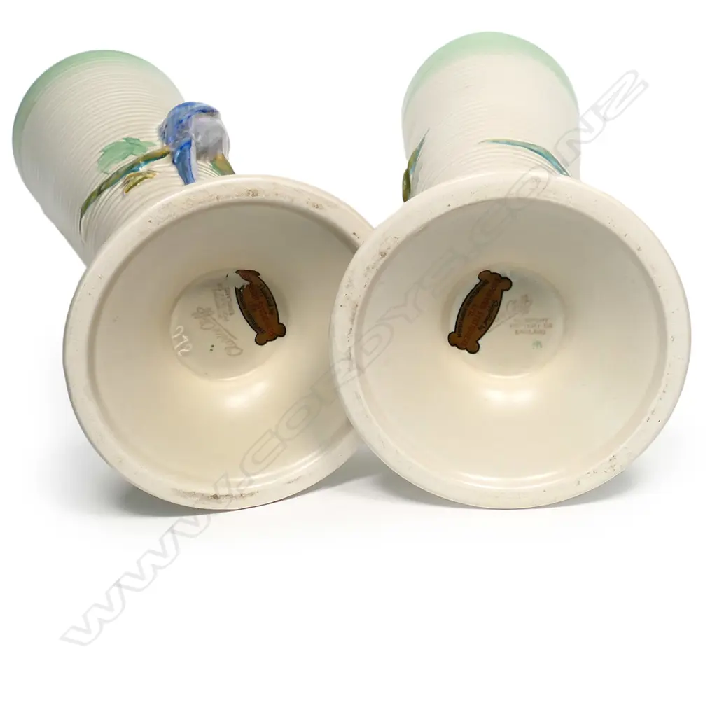 A pair of Clarice Cliff vases, shape 978, tapering conical, each modelled with two budgerigars in high relief. Printed backstamp and NZ retailer's decal. H.320mm. Image 1++