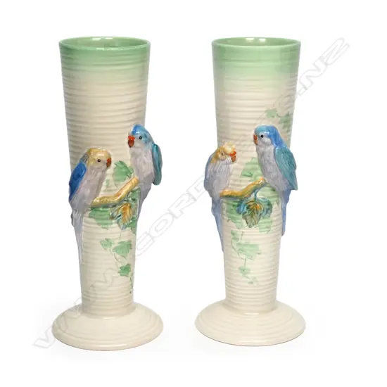 A pair of Clarice Cliff vases, shape 978, tapering conical, each modelled with two budgerigars in high relief. Printed backstamp and NZ retailer's decal. H.320mm.