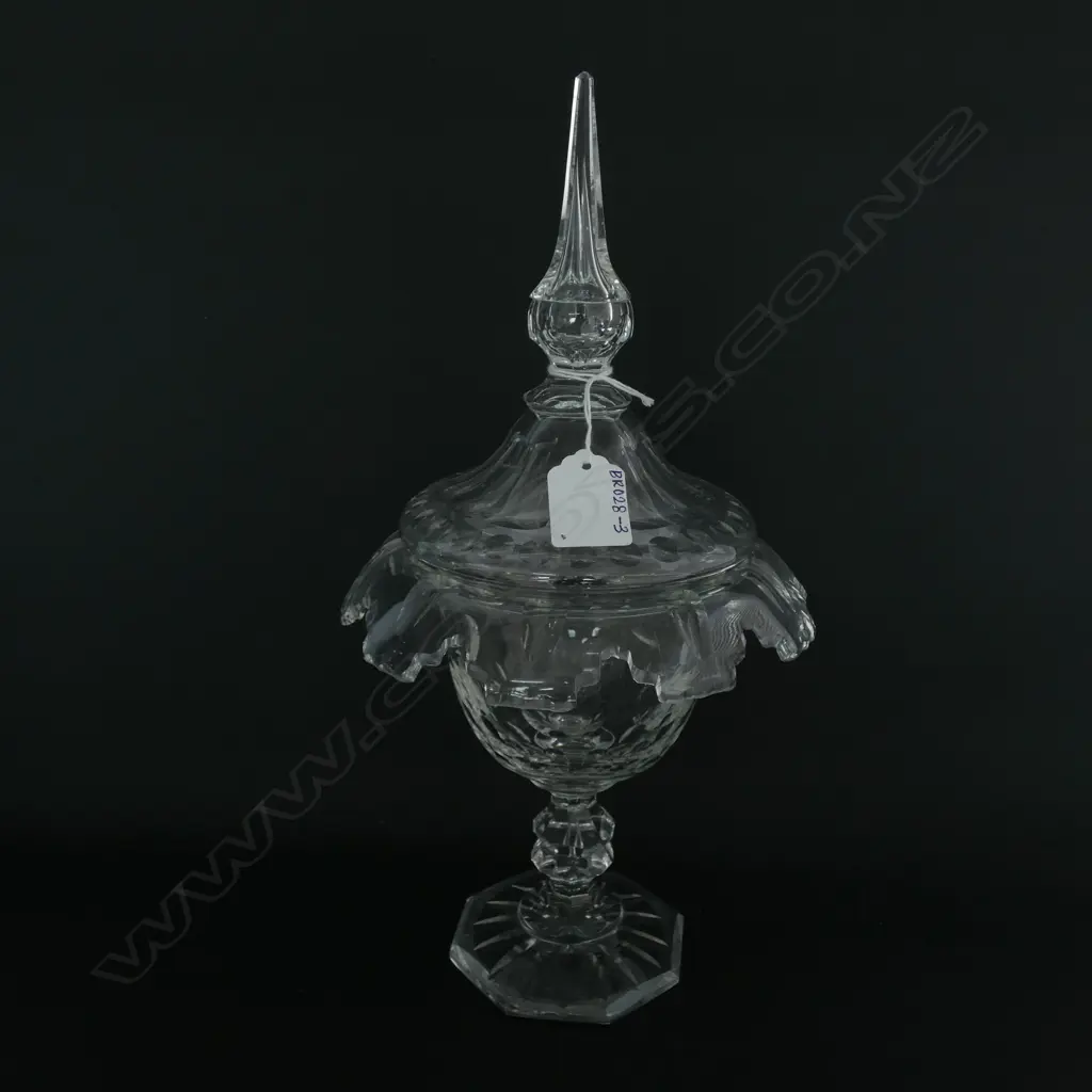 A Victorian crystal lidded sweetmeat dish, the fold over rim with castellated decoration, optic designs to the body and lid, double knop and round spreading foot to base.  180 x 330mm. Image 1++