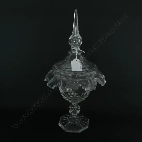 A Victorian crystal lidded sweetmeat dish, the fold over rim with castellated decoration, optic designs to the body and lid, double knop and round spreading foot to base.  180 x 330mm.