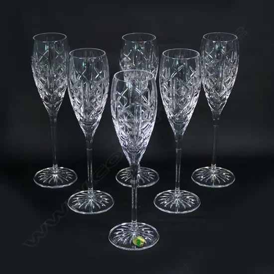 A set of six Waterford crystal champagne glasses, etched marks. Repeat diamond cut panels.