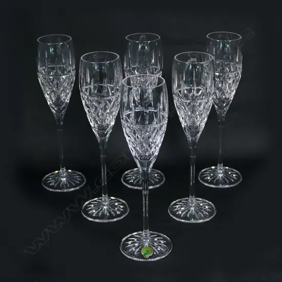 A set of six Waterford crystal champagne glasses, etched marks. Half diamond cut.