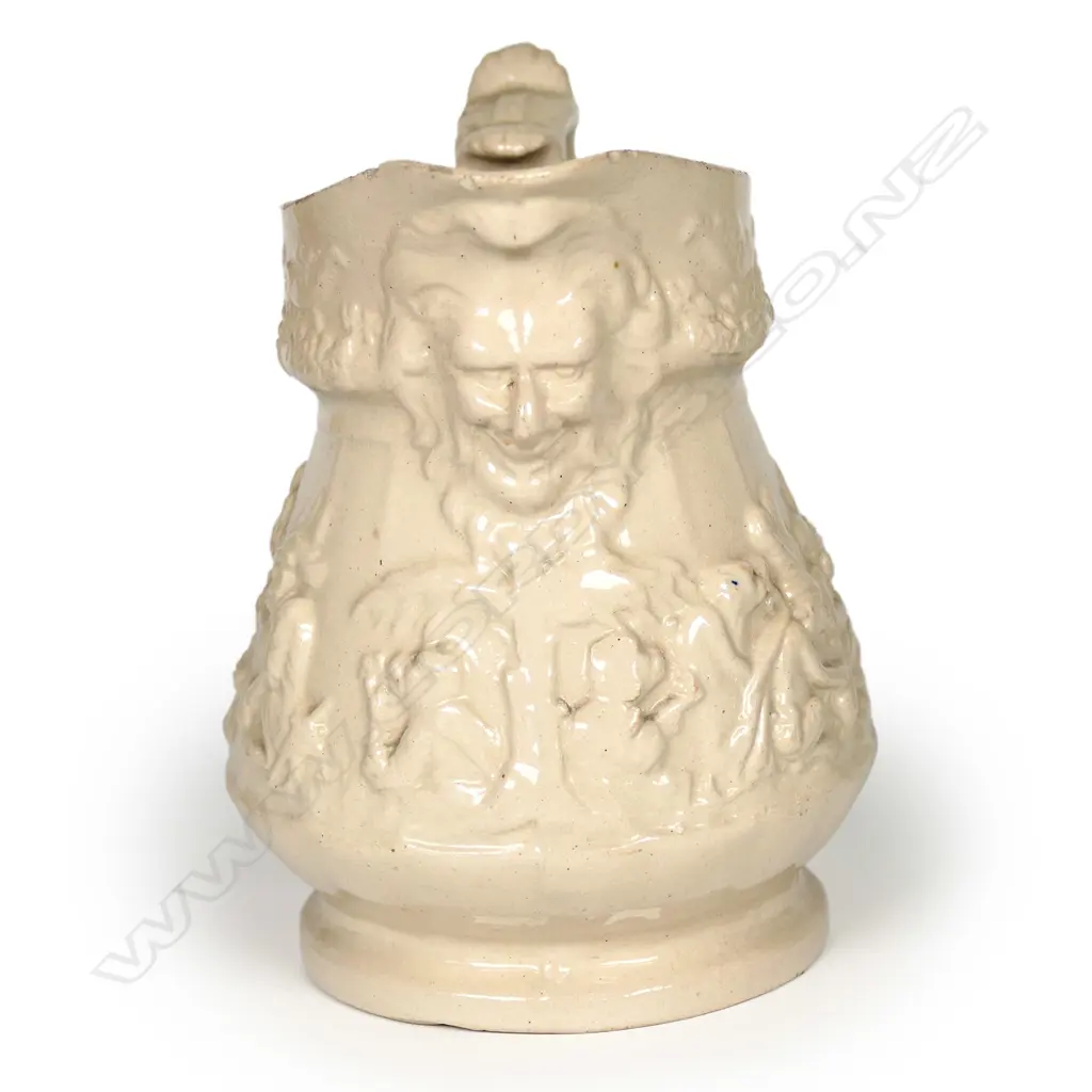 A 19thC drabware jug attributed to Ridgway or Meigh, decorated with anthropomorphic chimps in European and Eastern dress, smoking, drinking and gambling, some wearing plumed hats. A Bacchus mask moulded beneath the spout. H.135mm Image 1++