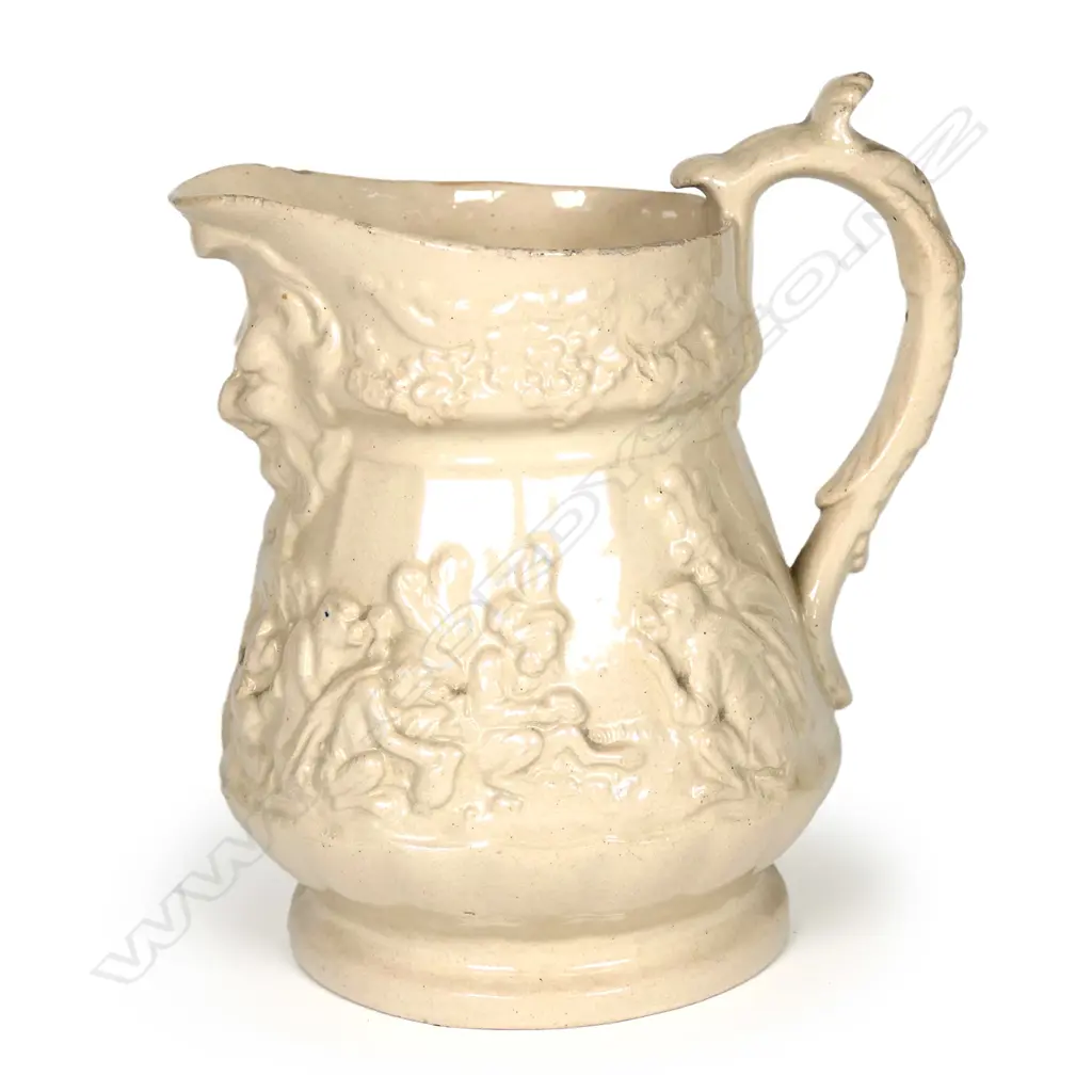 A 19thC drabware jug attributed to Ridgway or Meigh, decorated with anthropomorphic chimps in European and Eastern dress, smoking, drinking and gambling, some wearing plumed hats. A Bacchus mask moulded beneath the spout. H.135mm Image 1++