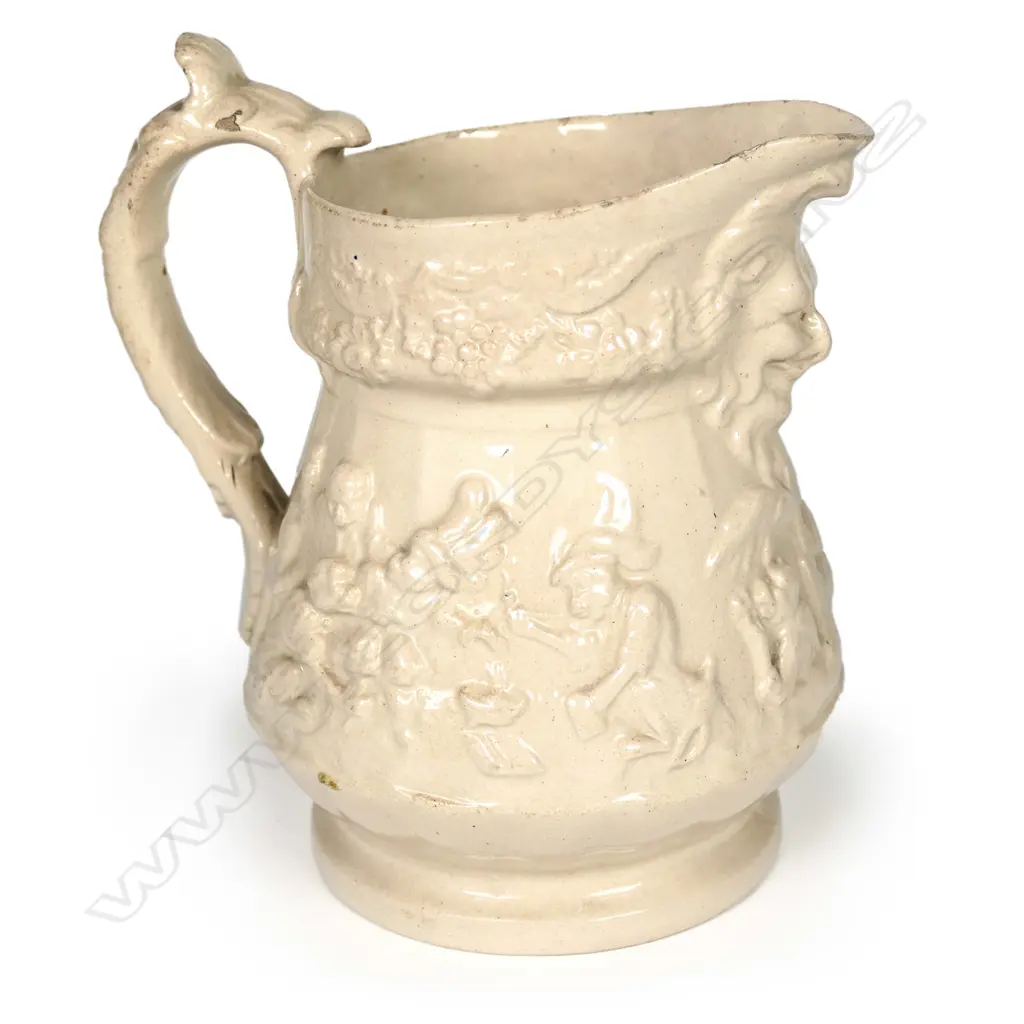 A 19thC drabware jug attributed to Ridgway or Meigh, decorated with anthropomorphic chimps in European and Eastern dress, smoking, drinking and gambling, some wearing plumed hats. A Bacchus mask moulded beneath the spout. H.135mm Image 1++