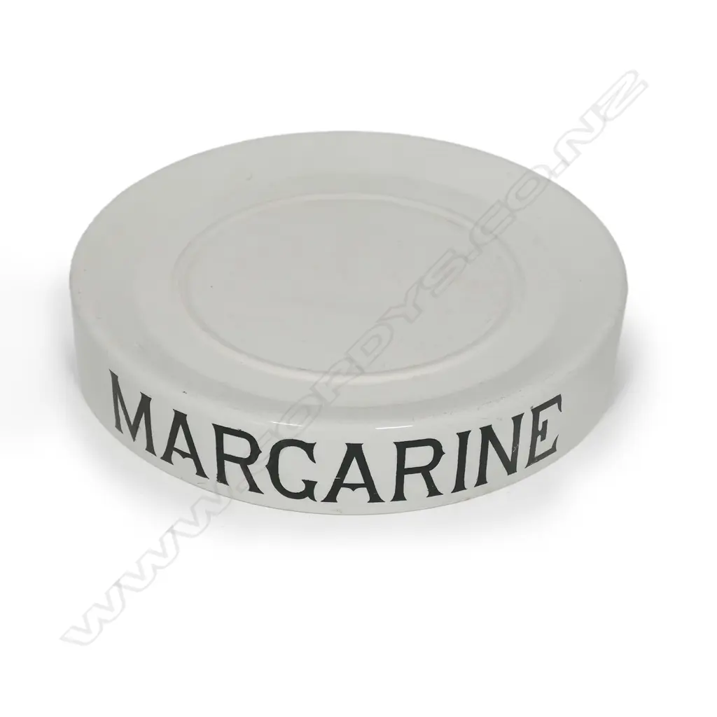 An early 20thC grocery shop display stand 'MARGARINE', glazed porcelain, circular slightly dished with carrying handles/cut outs. Chip under base. Dia.320mm Image 1++