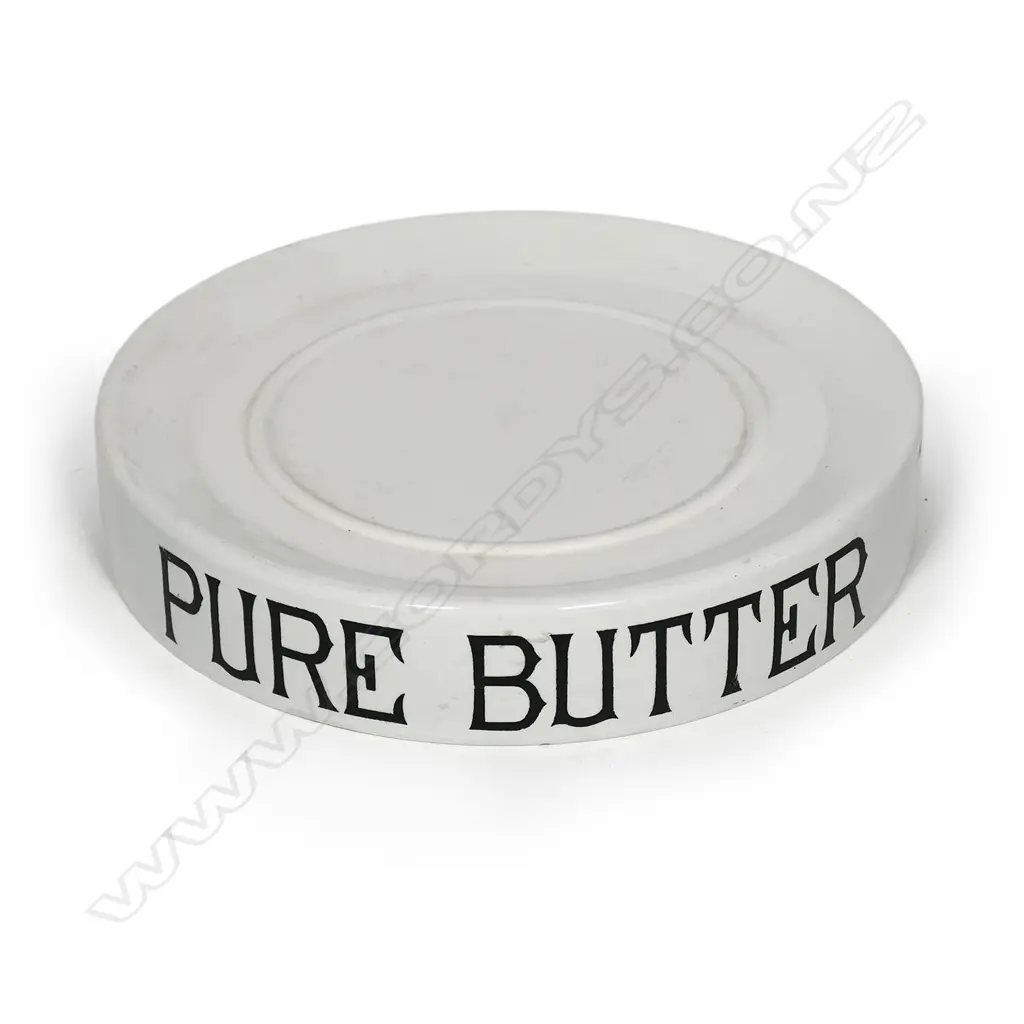 An early 20thC grocery shop display stand 'PURE BUTTER', glazed porcelain, circular slightly dished with carrying handles/cut outs. Dia.320mm Image 1++