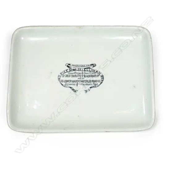 An early 20thC grocery shop glazed porcelain scales platter, oblong slightly dished, printed with shopfitters advertising decal. 375 x 280mm. Old chip to base.