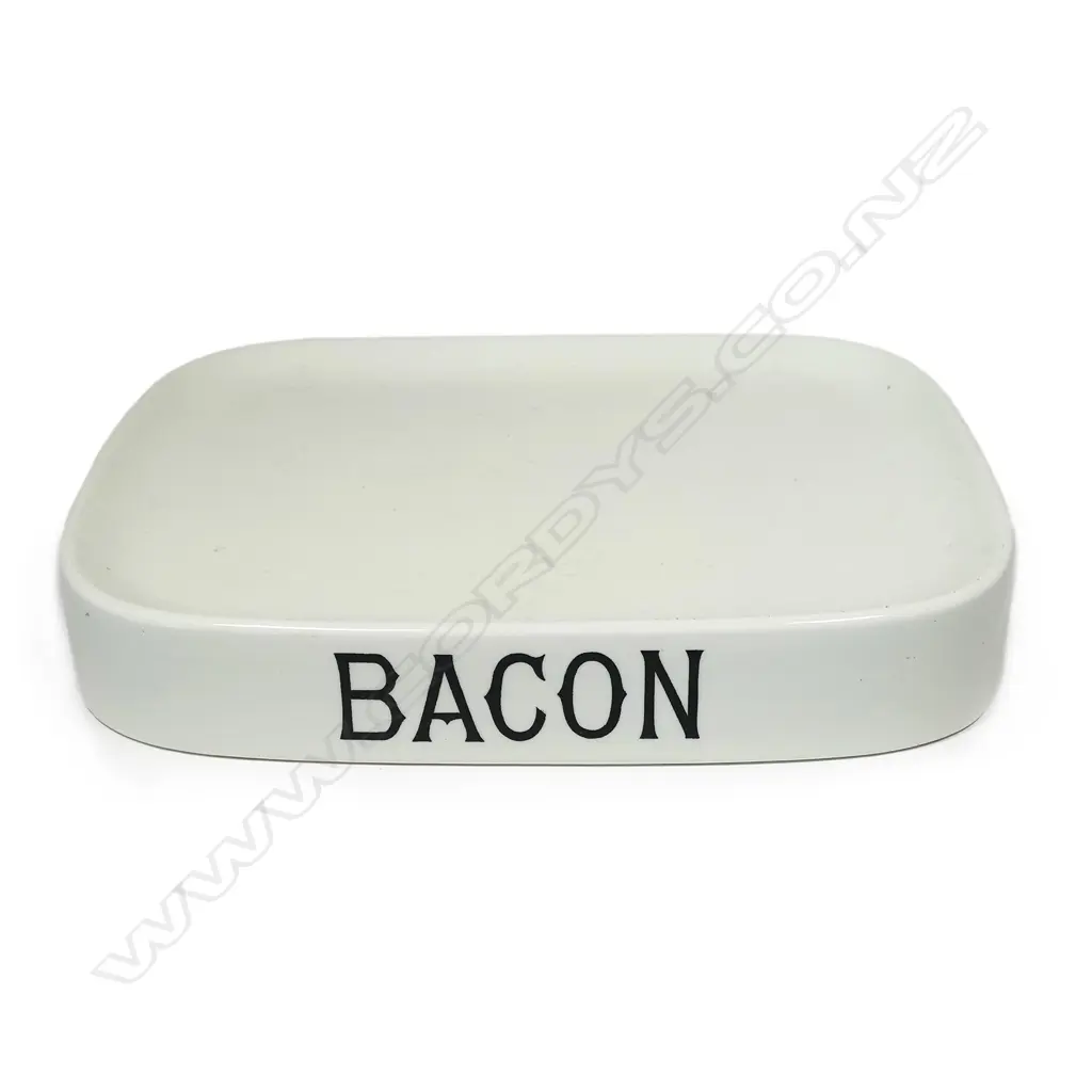 An early 20thC grocery shop display stand 'BACON', glazed porcelain, oblong slightly dished with carrying handles/cut outs.405 x 305mm Image 1++