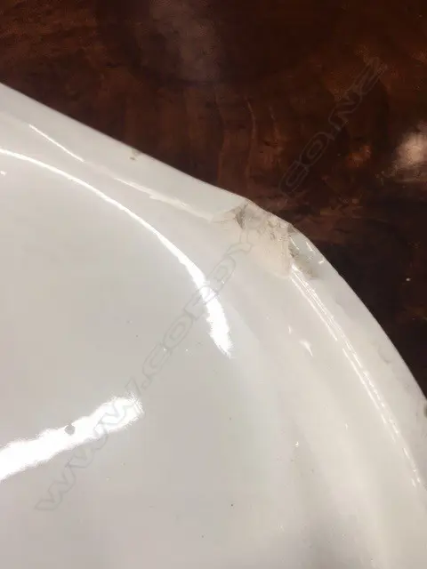 An early 20thC grocery shop display stand 'CHEESE', glazed porcelain, circular slightly dished with carrying handles/cut outs. Dia.320mm. Old chip to base. Image 1++