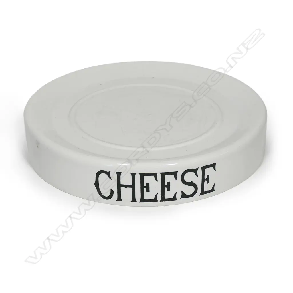 An early 20thC grocery shop display stand 'CHEESE', glazed porcelain, circular slightly dished with carrying handles/cut outs. Dia.320mm. Old chip to base. Image 1++