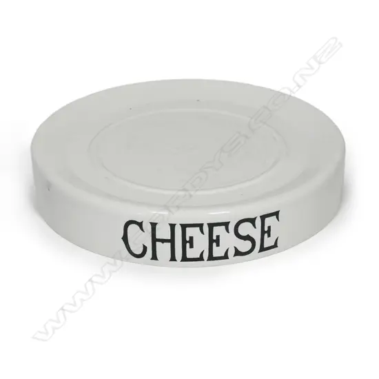 An early 20thC grocery shop display stand 'CHEESE', glazed porcelain, circular slightly dished with carrying handles/cut outs. Dia.320mm. Old chip to base.