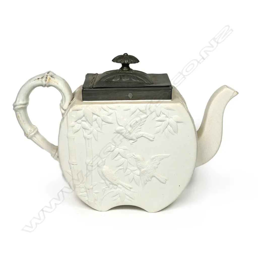 A Copeland salt glaze china Aesthetic period teapot, with pewter mounted cover and decorated with bamboo and birds. Registry mark c.1874. Small hairline at spout. W.255mm Image 1++