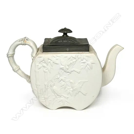 A Copeland salt glaze china Aesthetic period teapot, with pewter mounted cover and decorated with bamboo and birds. Registry mark c.1874. Small hairline at spout. W.255mm