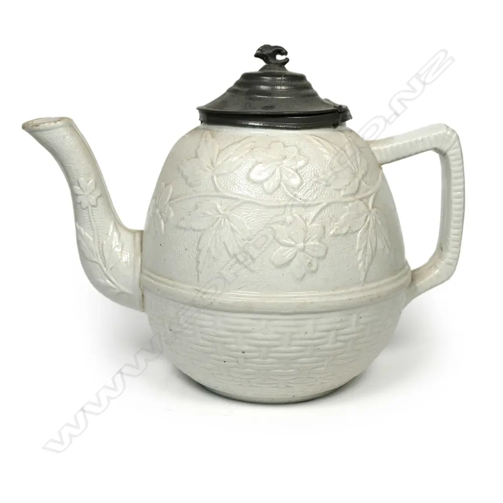 A salt glaze china Victorian period teapot, with pewter mounted cover and decorated with prunus and basket weave. Unmarked. W.230mm Image 1++