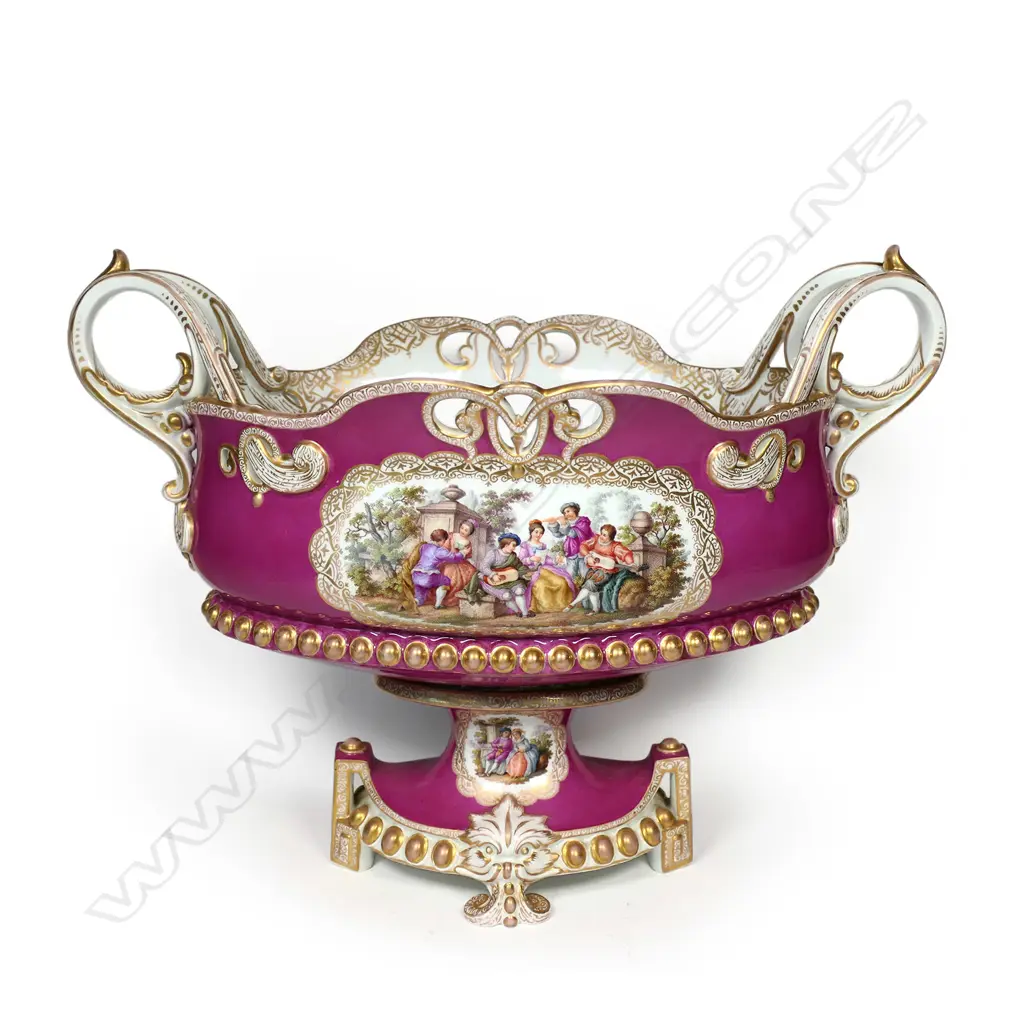 A 19thC KPM flower trough, pierced and gilded embellishment to the rim and base, scrolling side handles, the front with Angelica Kauffmann style garden scenes, the back decorated with wildflowers, on deep pink/puce ground.  370 x 200 x 280mm. Image 1++