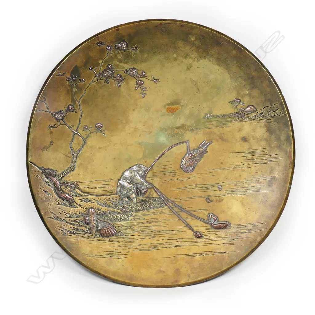 A Japanese Meiji period mixed metals plate, depicting a night-time cormorant fisher. Patination required. Engraved trademark for Nogawa workshops, Kyoto. Dia.305mm Image 1++