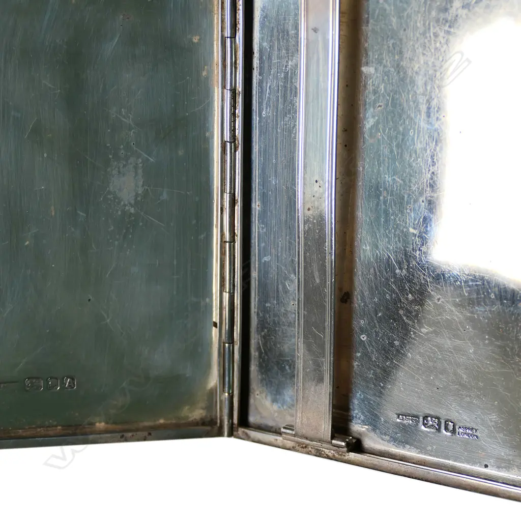 An unusual silver Art Deco cigarette case by Asprey & Co, London, the lid engraved with a map of Western Europe and the Mediterranean, with the capital cities named. The cartography detailed with various plain and machine engraved grounds. Black onyx thumbpiece, the interior with a hinged solid retaining bar. London 1936. 115 x 82 x 10mm. 189gm. Image 1++