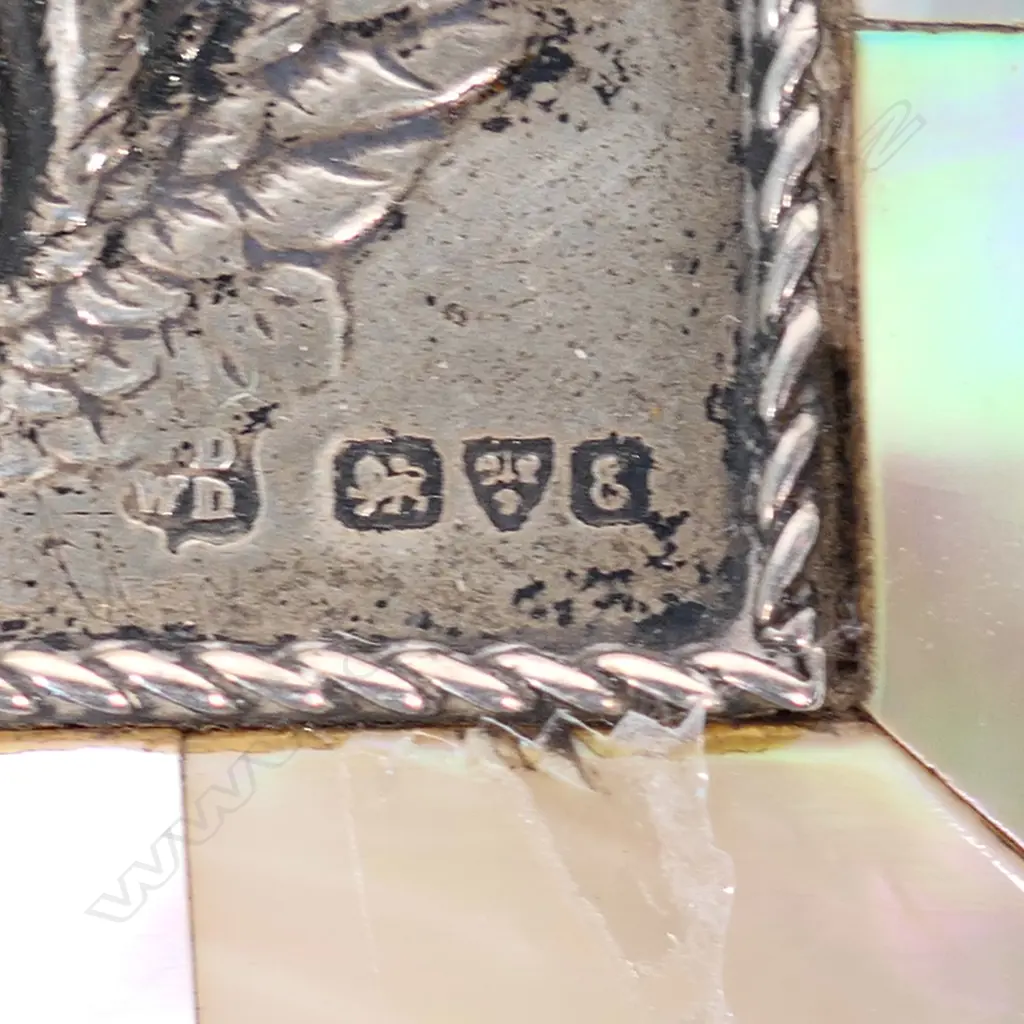 An Edwardian mother-of-pearl and silver jewel casket, panelled body, the silver lid embossed with a Reynolds angel. Silk and velvet lined two ring interior. Compressed ball feet. Chester 1905. 73 x 46 x 40mm. Image 1++