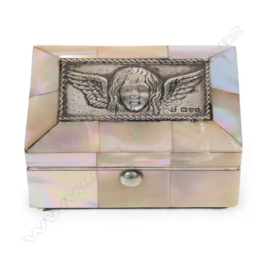 An Edwardian mother-of-pearl and silver jewel casket, panelled body, the silver lid embossed with a Reynolds angel. Silk and velvet lined two ring interior. Compressed ball feet. Chester 1905. 73 x 46 x 40mm.