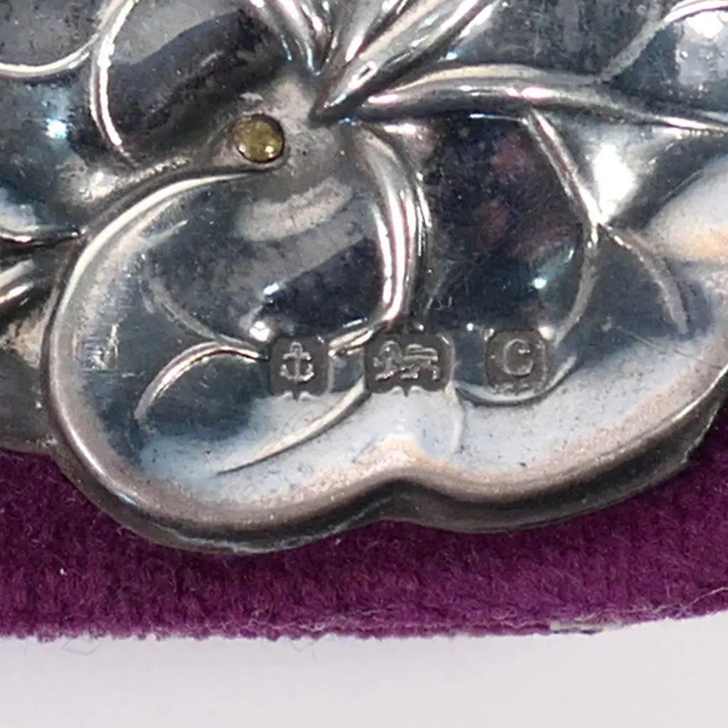 An Edwardian silver Art Nouveau photo frame, waterlily leaf and flower repeating embossed border on maroon velvet. Velvet back with wooden strut. 180 x 185mm. Birmingham 1902 by William Devonport. Minor faults consistent with age. Image 1++