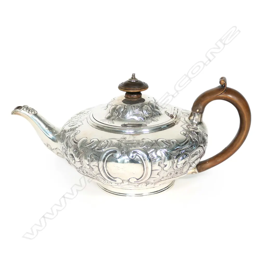 A Victorian silver teapot, squat circular with domed hinged lid, floral chased and engraved; boxwood handle and finial. London 1848, probably by Walter Morrisse. 458gm. Image 1++