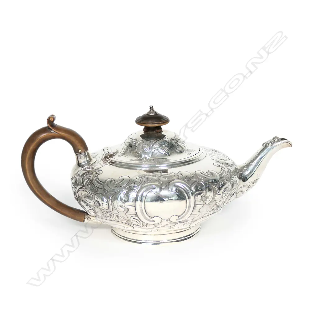 A Victorian silver teapot, squat circular with domed hinged lid, floral chased and engraved; boxwood handle and finial. London 1848, probably by Walter Morrisse. 458gm. Image 1++