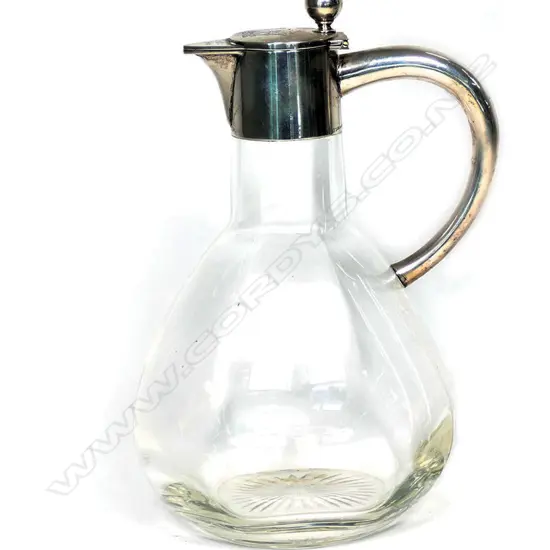 An early 1900 German 800 silver mounted claret jug, undecorated body with plain silver top, monogram to lid, German silver marks. 130 x 110mm.