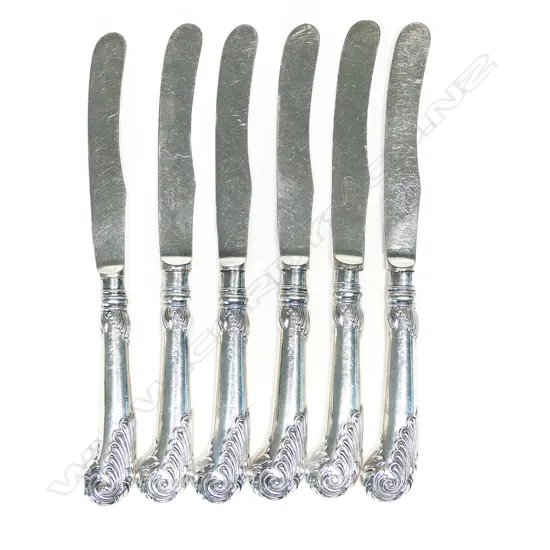 A set of six silver pâté knives, with acanthus capped pistol grip handles, silver plated blades. Sheffield 1920 by Yates Bros.