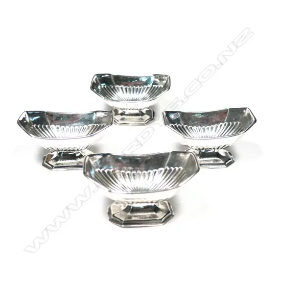 A set of four Vict silver salts, oblong boat shape, fluted, raised on conforming bases. Sheffield 1886 by Levesley Bros. 140gm
