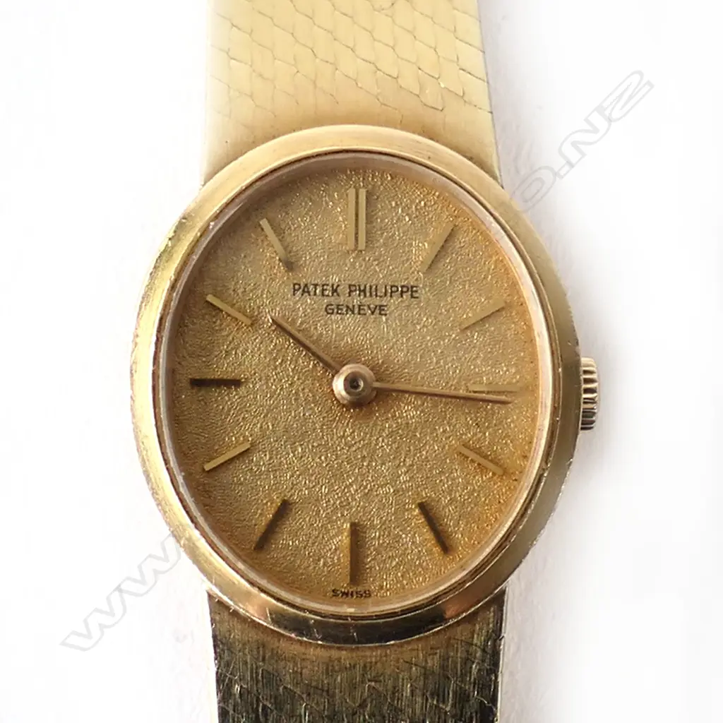 A vintage 18ct gold lady’s Patek Philippe wristwatch, oval case with gilt dial and original 18ct PP integral mesh strap and latch clasp with makers emblem. 41.3gm total. Image 1++