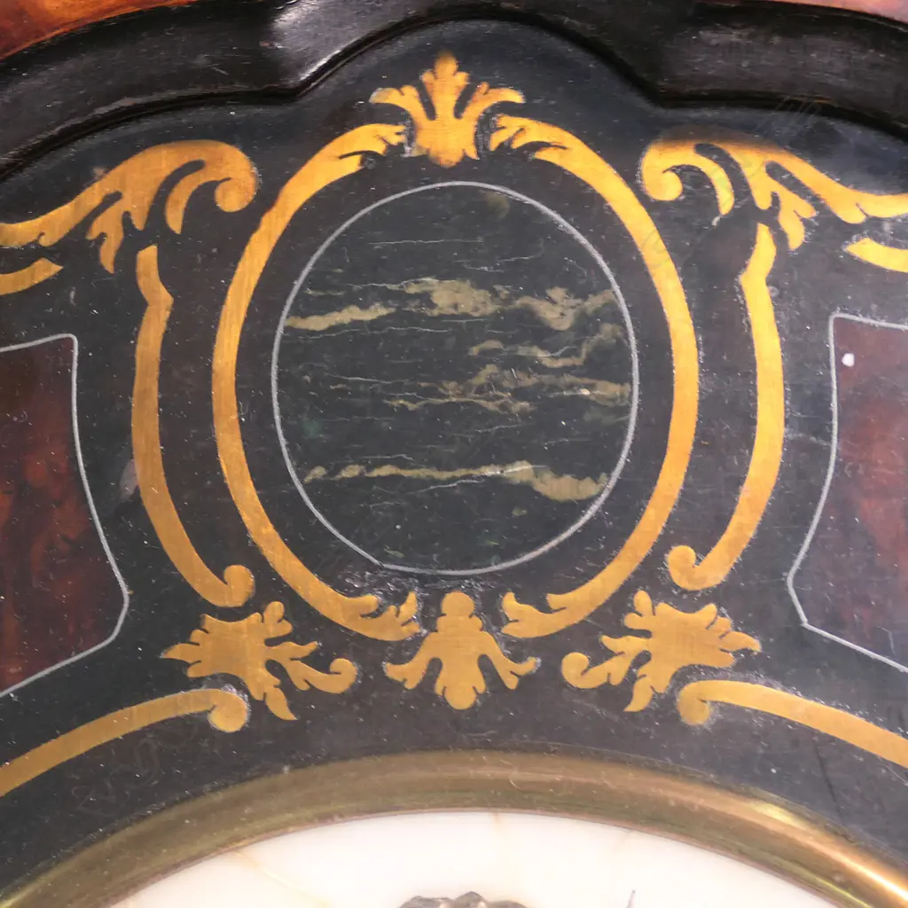 A 19thC French country wall clock, with serpentine oval 'picture frame' case, glazed and displaying a bezel set with decorative agate panels framing a marble dial (repaired) with enamel cartouche hours. Gong striking movement requires attention. 605 x 505mm. Provenance: The estate collection of Prof. G. Dawson. Image 1++