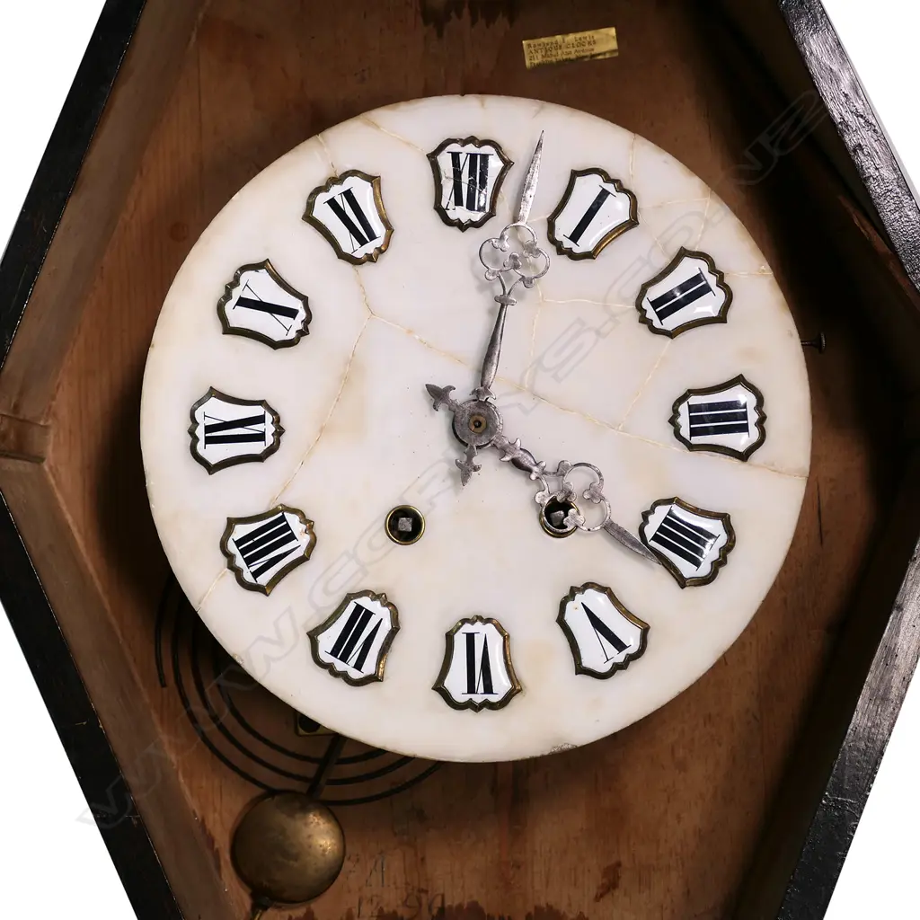 A 19thC French country wall clock, with serpentine oval 'picture frame' case, glazed and displaying a bezel set with decorative agate panels framing a marble dial (repaired) with enamel cartouche hours. Gong striking movement requires attention. 605 x 505mm. Provenance: The estate collection of Prof. G. Dawson. Image 1++