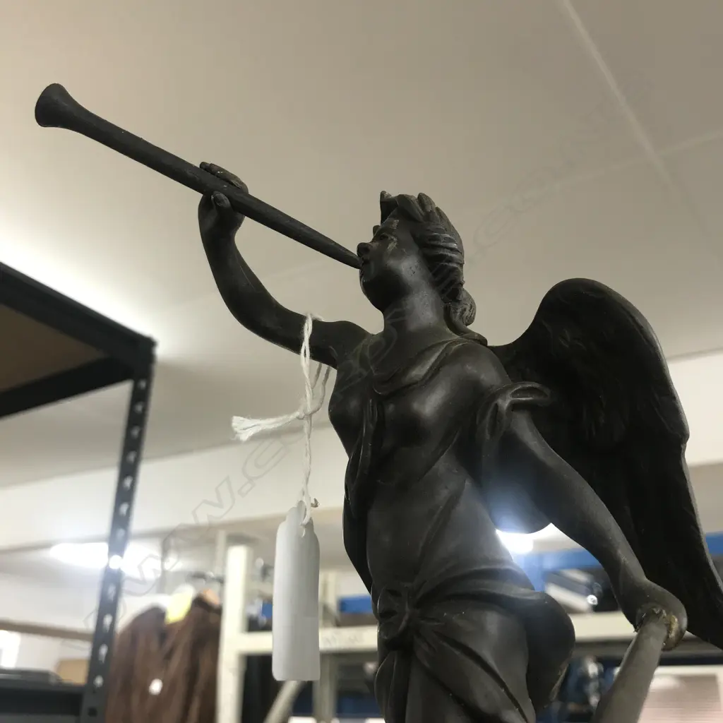 A Louis XVI-style mantel clock, the shaped case inlaid with cut brass Boulle work on black lacquered ground and heavily tarnished rococo ormolu mounts, surmounted by a pagoda top crowned by a standing heraldic angel figure. The cast dial with white enamel hour cartouches with blue Roman numerals, gong striking movement, sunburst pendulum above a sloping checkered floor, behind a glazed door mounted with a floral adorned putti. H.640mm. Image 1++